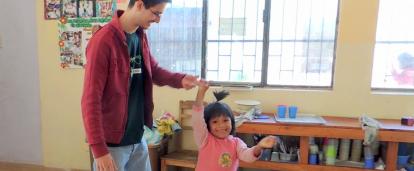 Early Childhood Development volunteer dancing with a child at his placement Projects Abroad Early Childhood Development volunteer dancing with a child during his spring break project placement